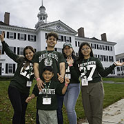 A family of five stands in front of Dartmouth Hall in ’27 T-shirts