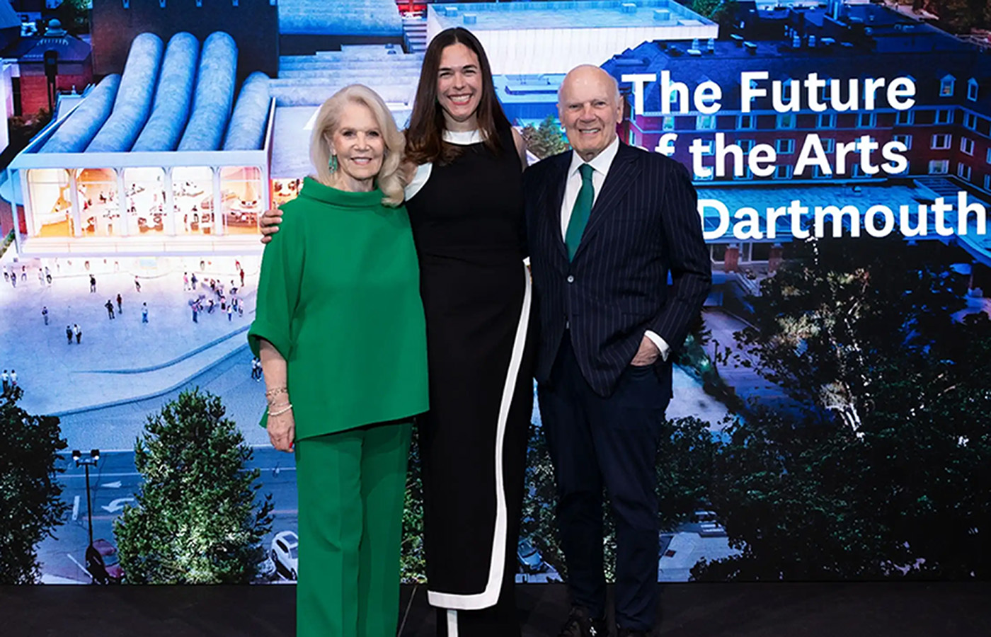 Daryl Roth, President Sian Beilock, and Steven Roth stand on stage in front of an rendering of the new Hopkins Center with the words The Future of the Arts at Dartmouth written on the image