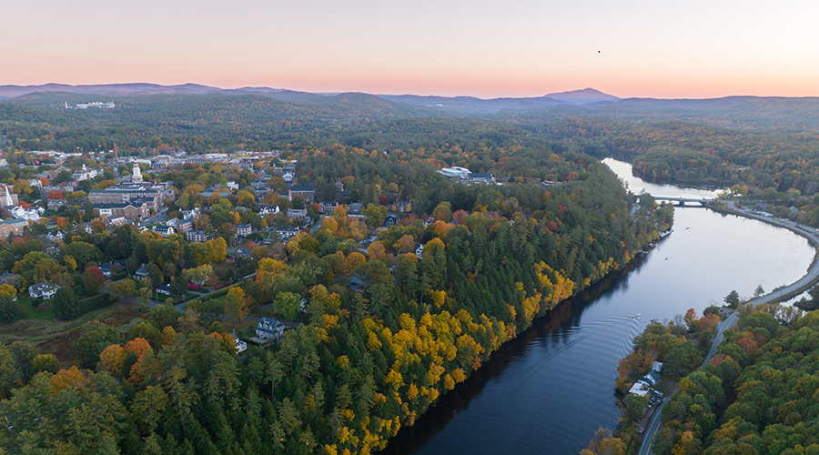 Drone shot of Dartmouth campus in the fall overlooking the Connecticut River