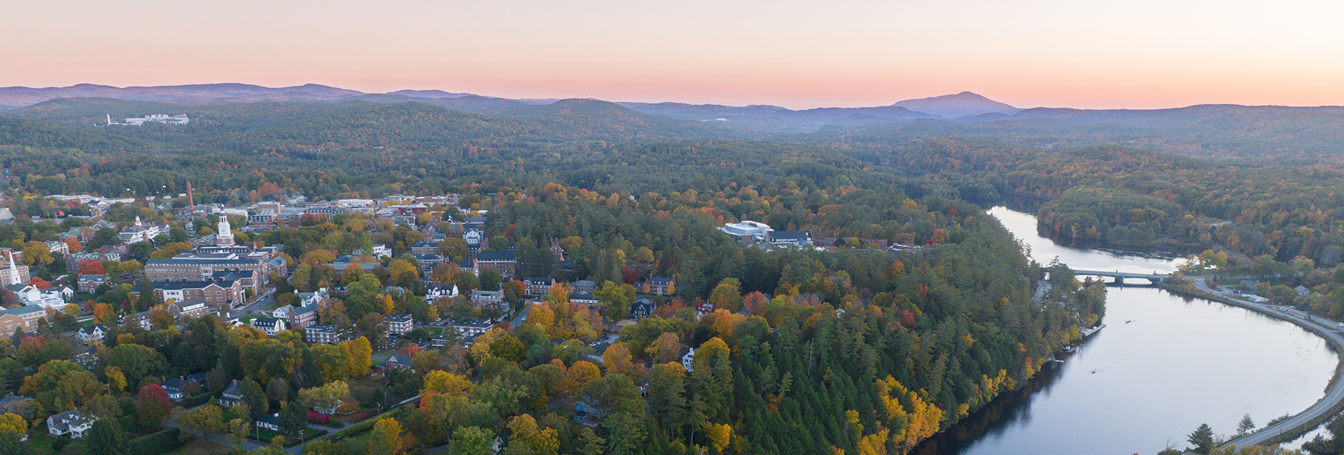 Drone shot of Dartmouth campus in the fall overlooking the Connecticut River