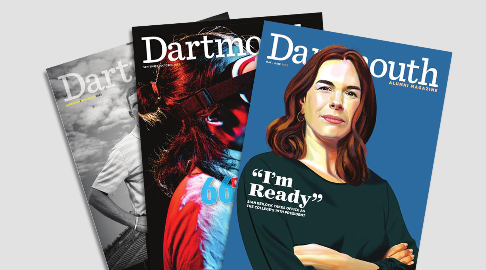 Three covers of Dartmouth Alumni Magazine scattered on a flat surface