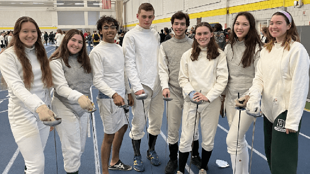 The fencing team poses for a photo after a competition