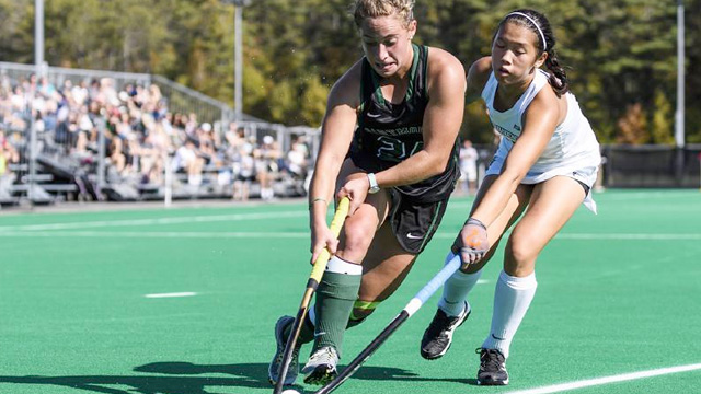 A Dartmouth field  hockey player stickhandles past an opponent during a game