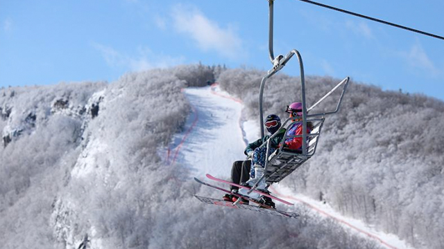 Two students take the chairlift to the top of the Dartmouth Skiway