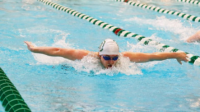 A Dartmouth swimmer comes up for air mid breaststroke