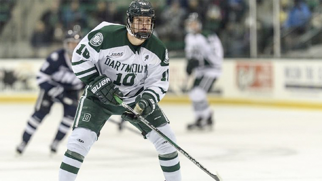 Dartmouth hockey player wearing number 10 skates to the front of the net looking for a pass