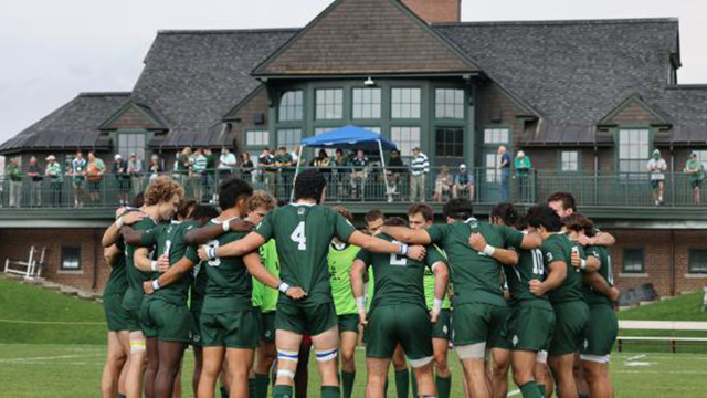 The men's rugby team in a circle before a game