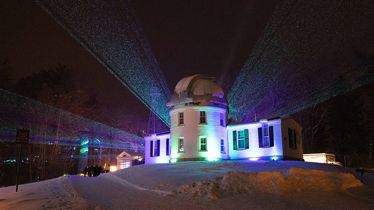 Image of the observatory lit up at night with many color lights during BEMA Lights
