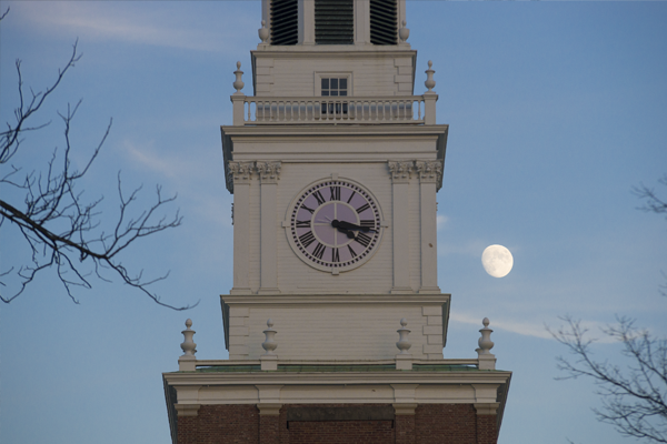 Baker Tower clock with moon in the background