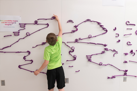 Child playing with interactive wall