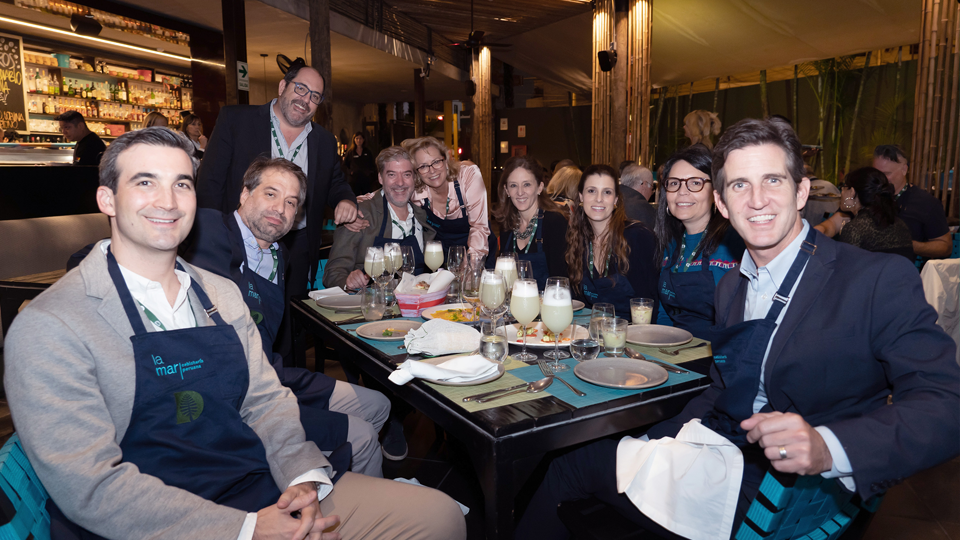 Group of attendees smiling in a restaurant in Peru
