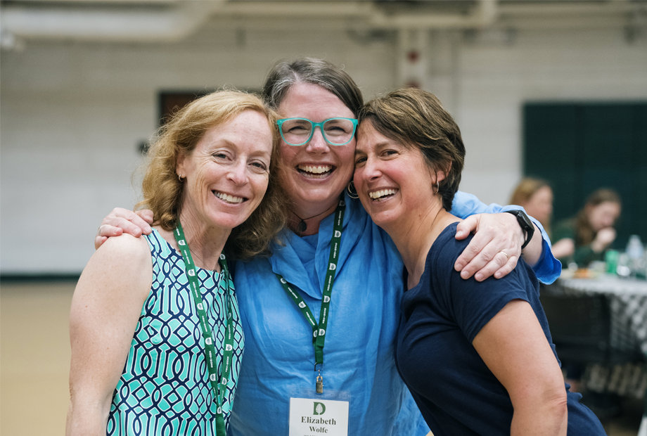 Women embracing and smiling at Reunions 2023