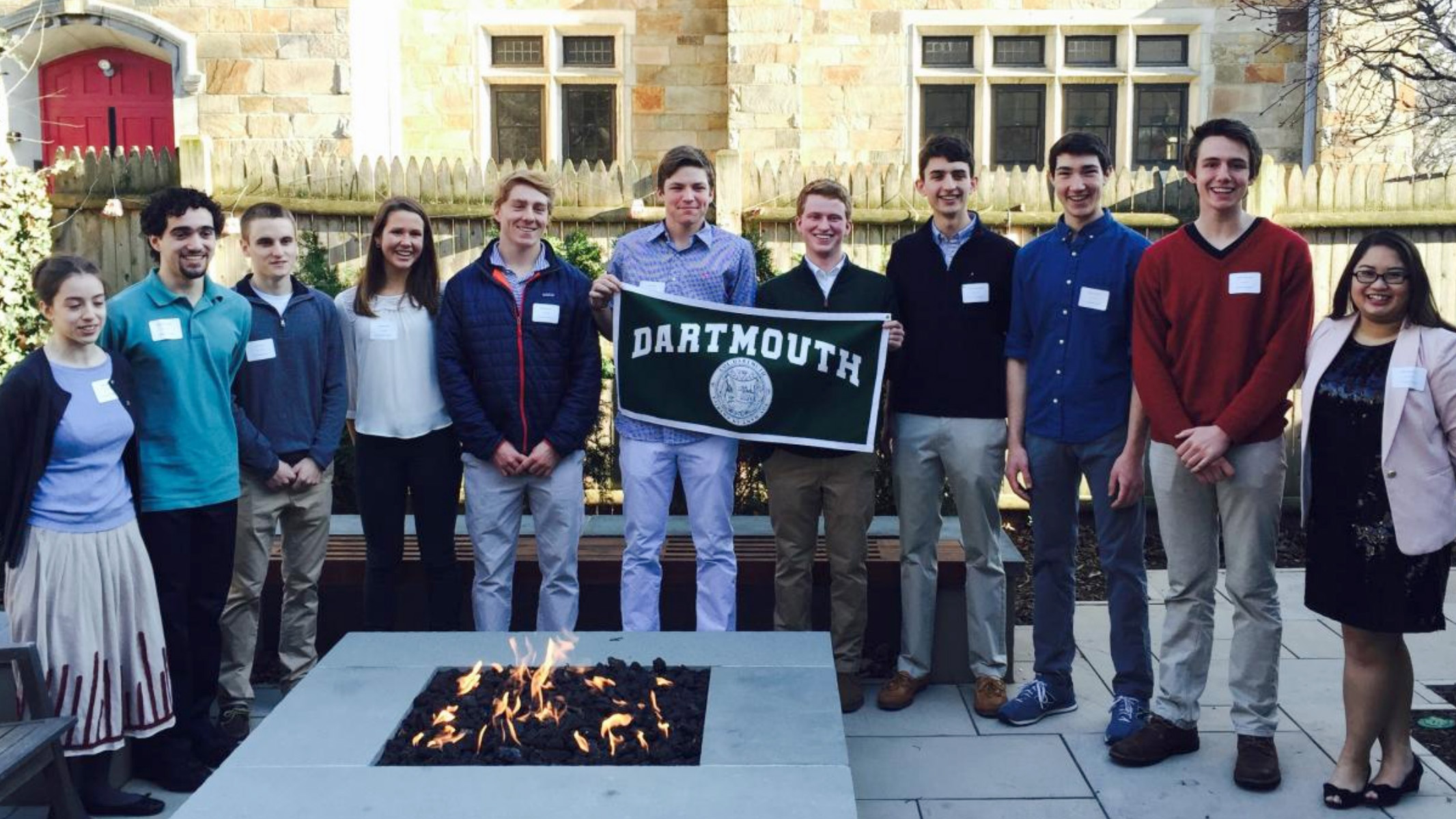 group of students holding a Dartmouth banner