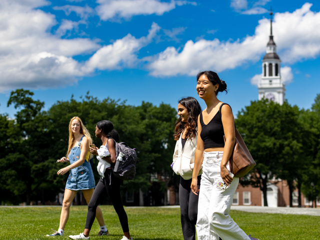 Students walking across the Green on a sunny day