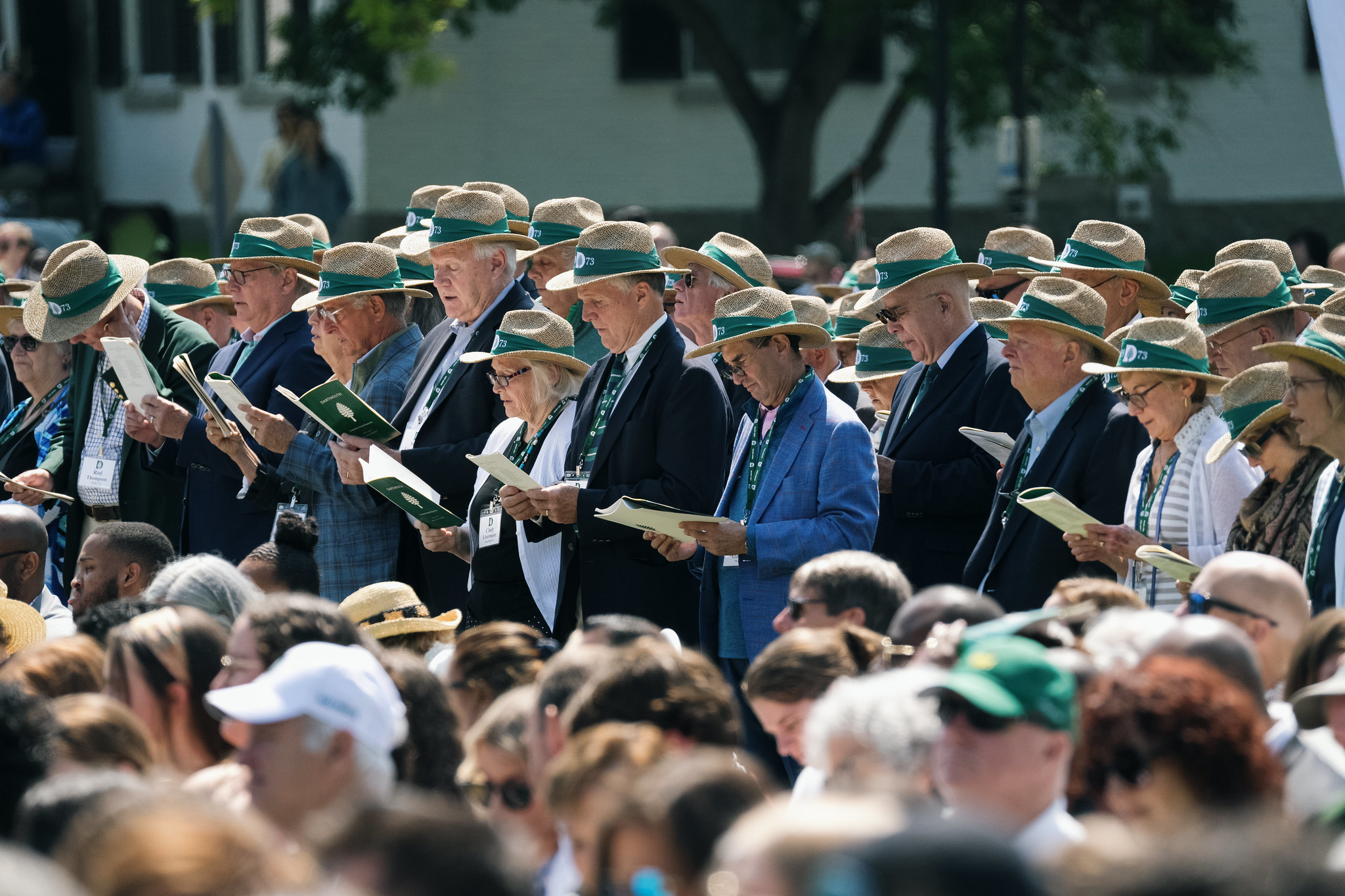 Class of 73 at commencement in matching straw hats.