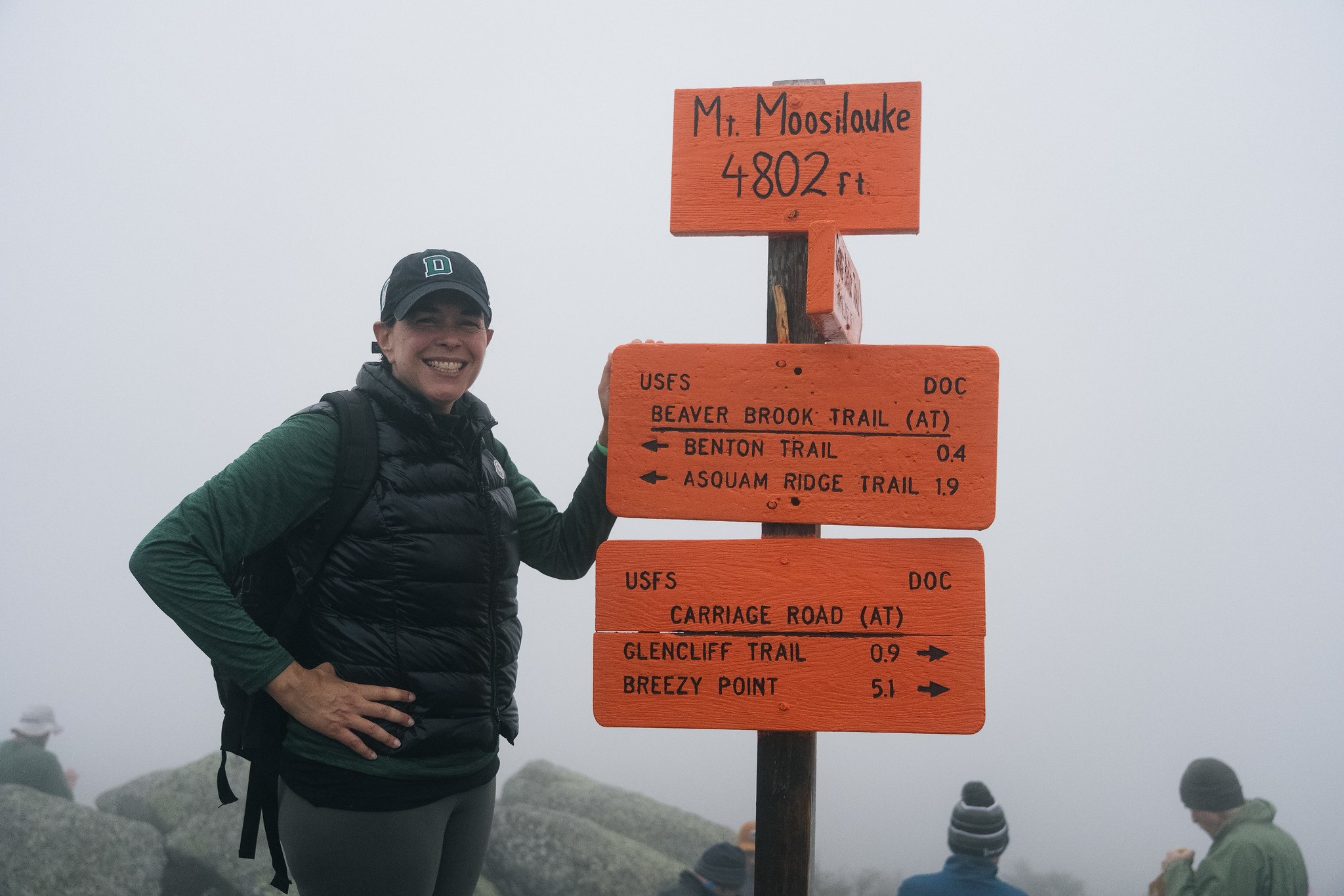 President Beilock with sign post on top of Mt. Moosilauke. 