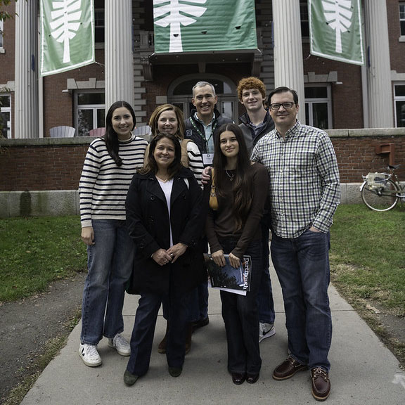 A family standing in front of Collis during Family Weekend 