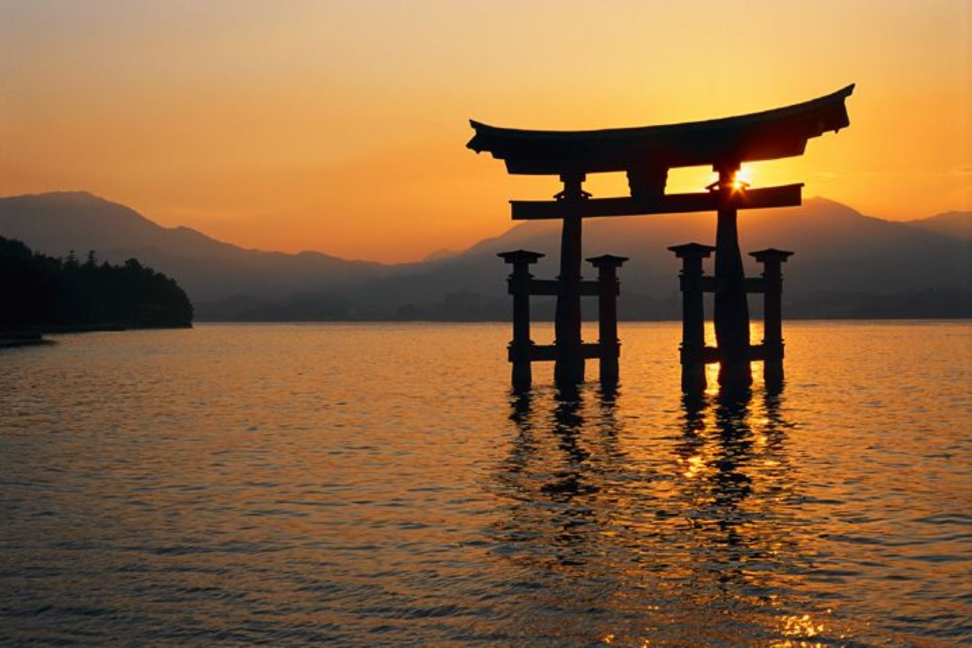 sunset over water in japan with structure in water