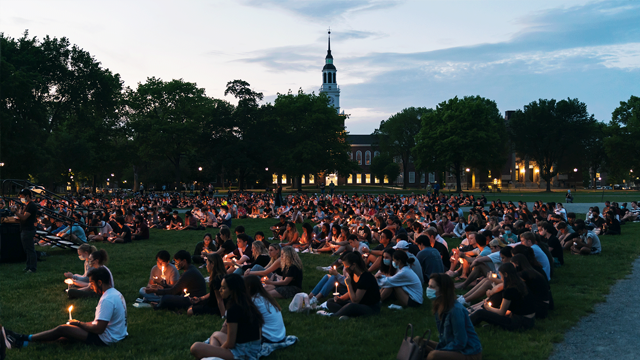 Students at a candlelight vigil on Baker Lawn