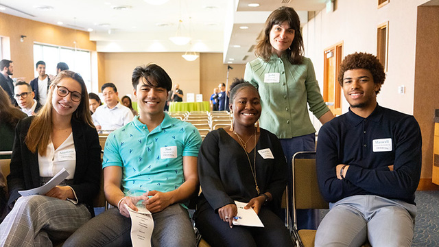 A group of young alumni posing for a photo at a Dartmouth-sponsored networking event. 