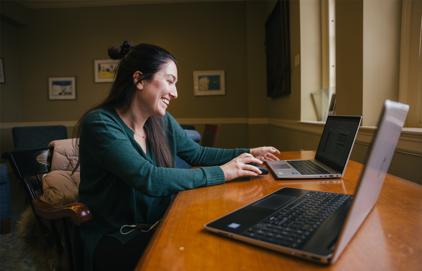 Woman smiling and working at her laptop