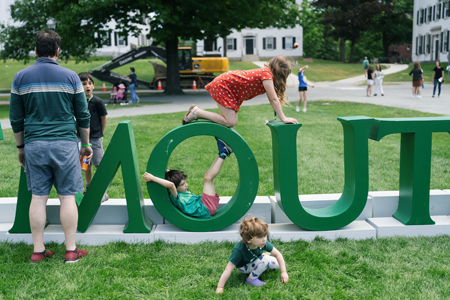 Kids playing on the giant DARTMOUTH letters at Reunions 2024