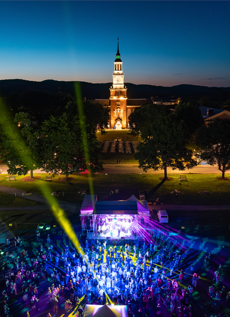 Dartmouth Hall at night with the On the Green strobe light celebration in the foreground