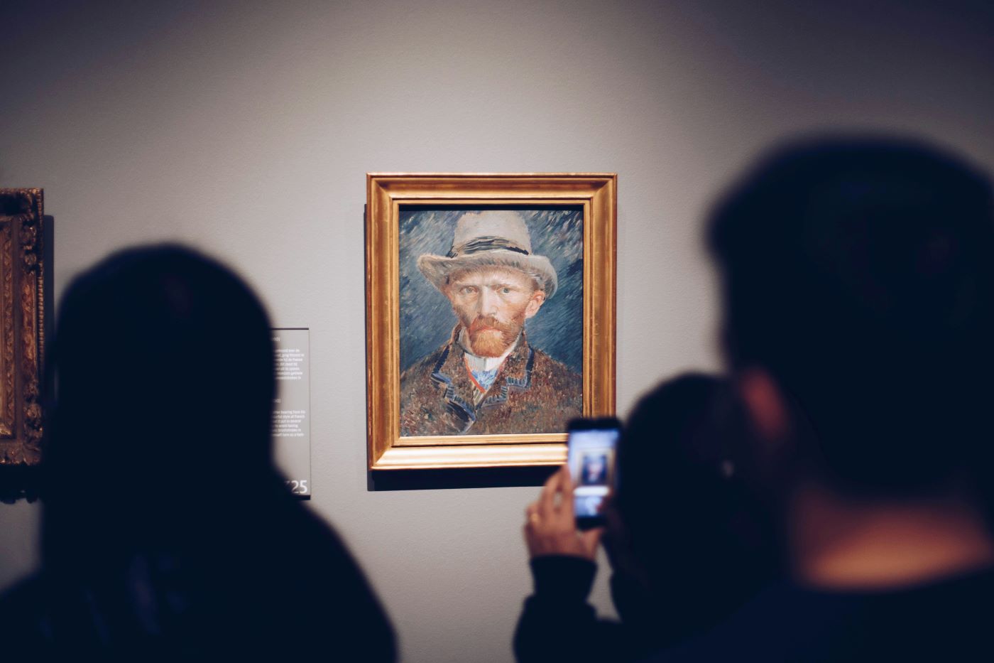 A person taking a photo of Van Gogh's self portrait