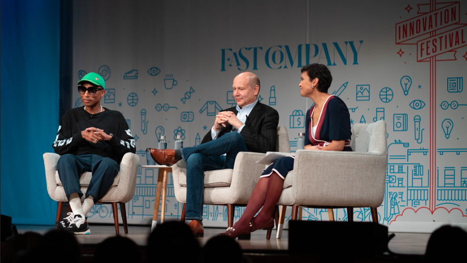 Pharrell, seated at left and Chris Meledandri, seated in the middle, speaking at a panel at the Fast Company Innovation Festival.