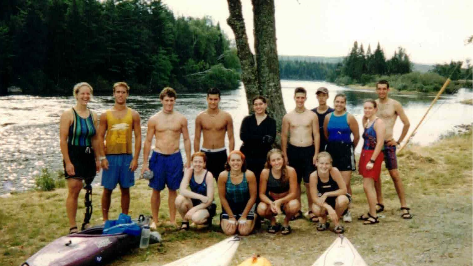 A group of trippies from the Class of 2003 posing by the river. 