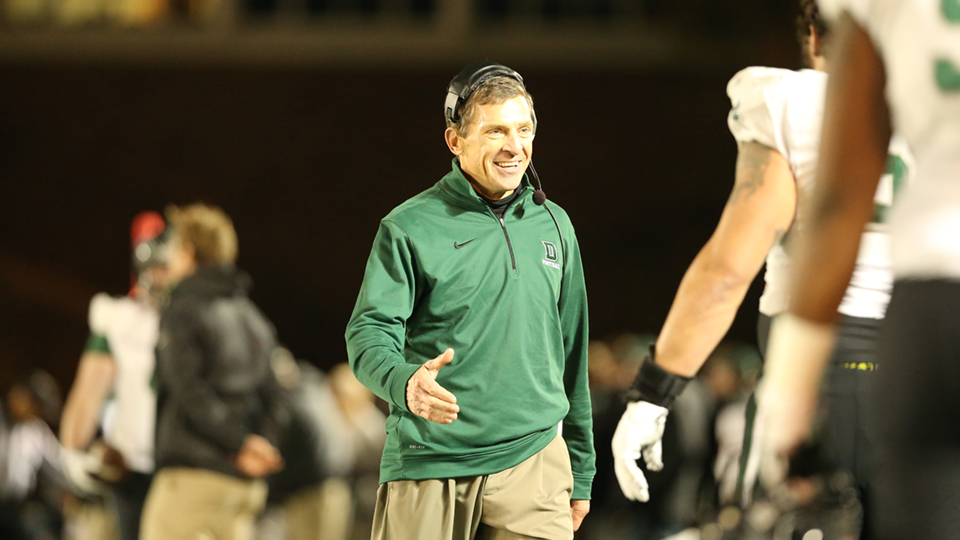 Buddy Teevens walks across the field ready to shake hands with his players at a Dartmouth football game