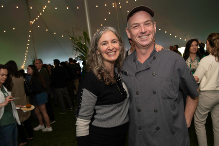 Two parents posing in one of the event tents. 