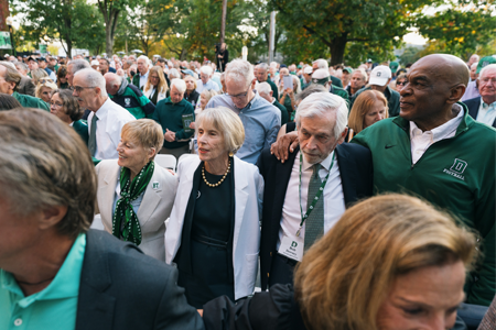 Crowd swaying and smiling at dedication ceremony