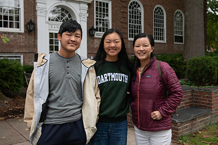 Student smiling with family outside