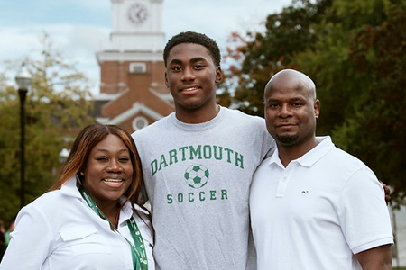 Family smiling with Baker Tower in the background