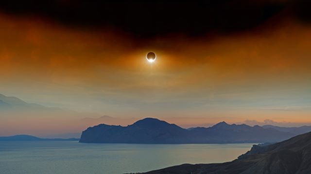 Solar eclipse over mountains