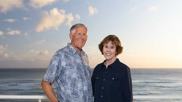 A photo of David Mulliken and his wife Noreen, standing on a balcony overlooking the ocean