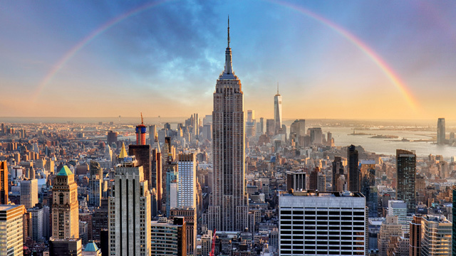 A photo of the NYC skyline with a rainbow