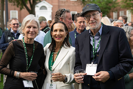 Members of the class of 1975 posing together at a dinner reception