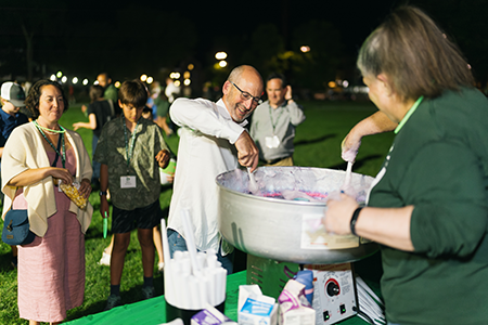 Reunions attendees participate in cotton candy making on the green