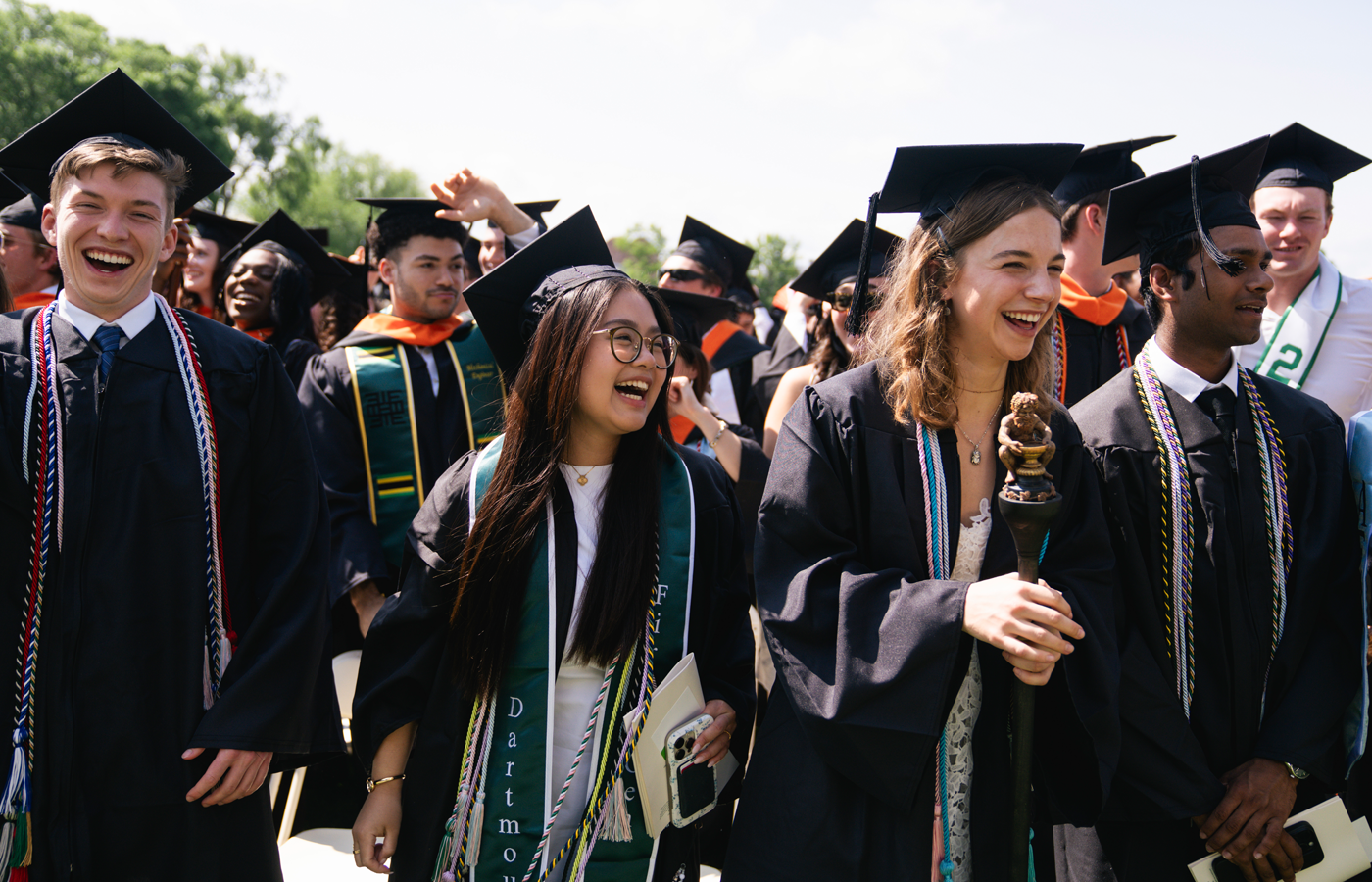 Graduates smiling and celebrating at Commencement