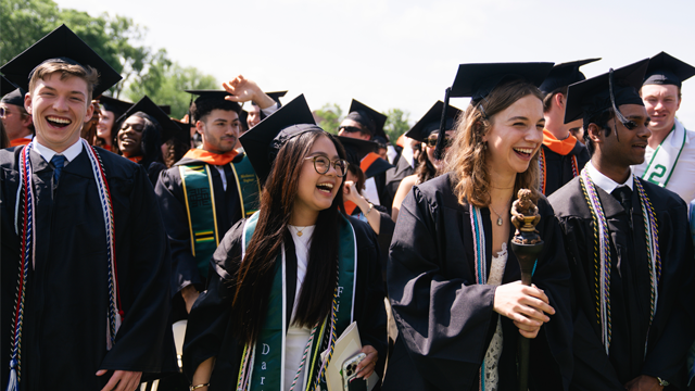 Graduates smiling and celebrating at Commencement