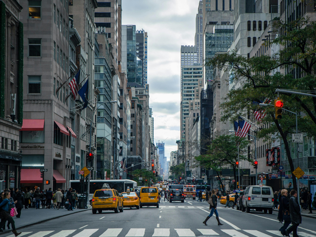 View of cabs racing along New York City street