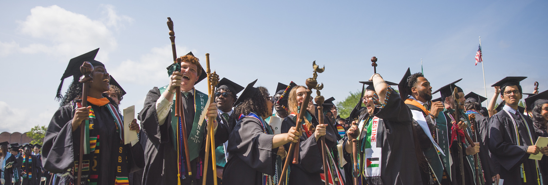 Graduates with staffs jubilant at Commencement 2025