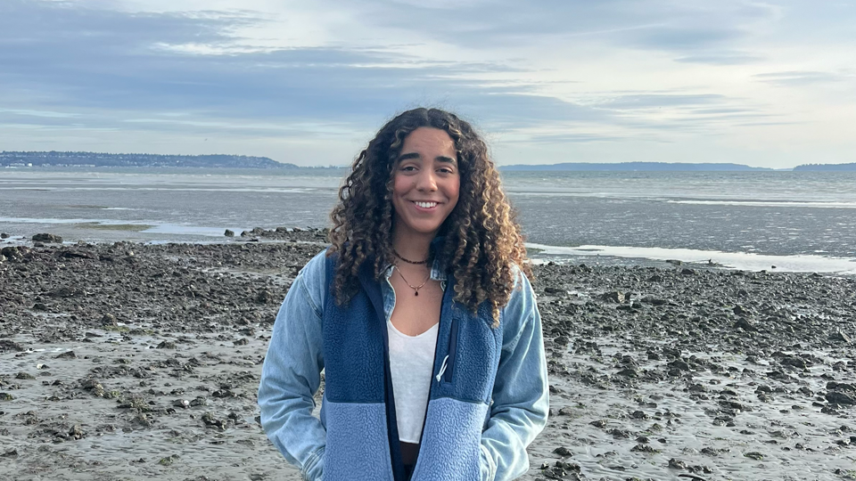 Grace Caldwell in front of an Alaskan seascape