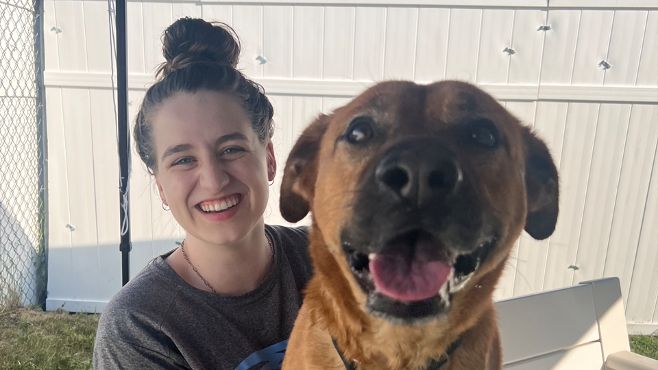 Rachel Hall posing with a dog