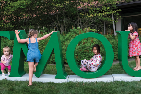 Kids playing on giant DARTMOUTH letters