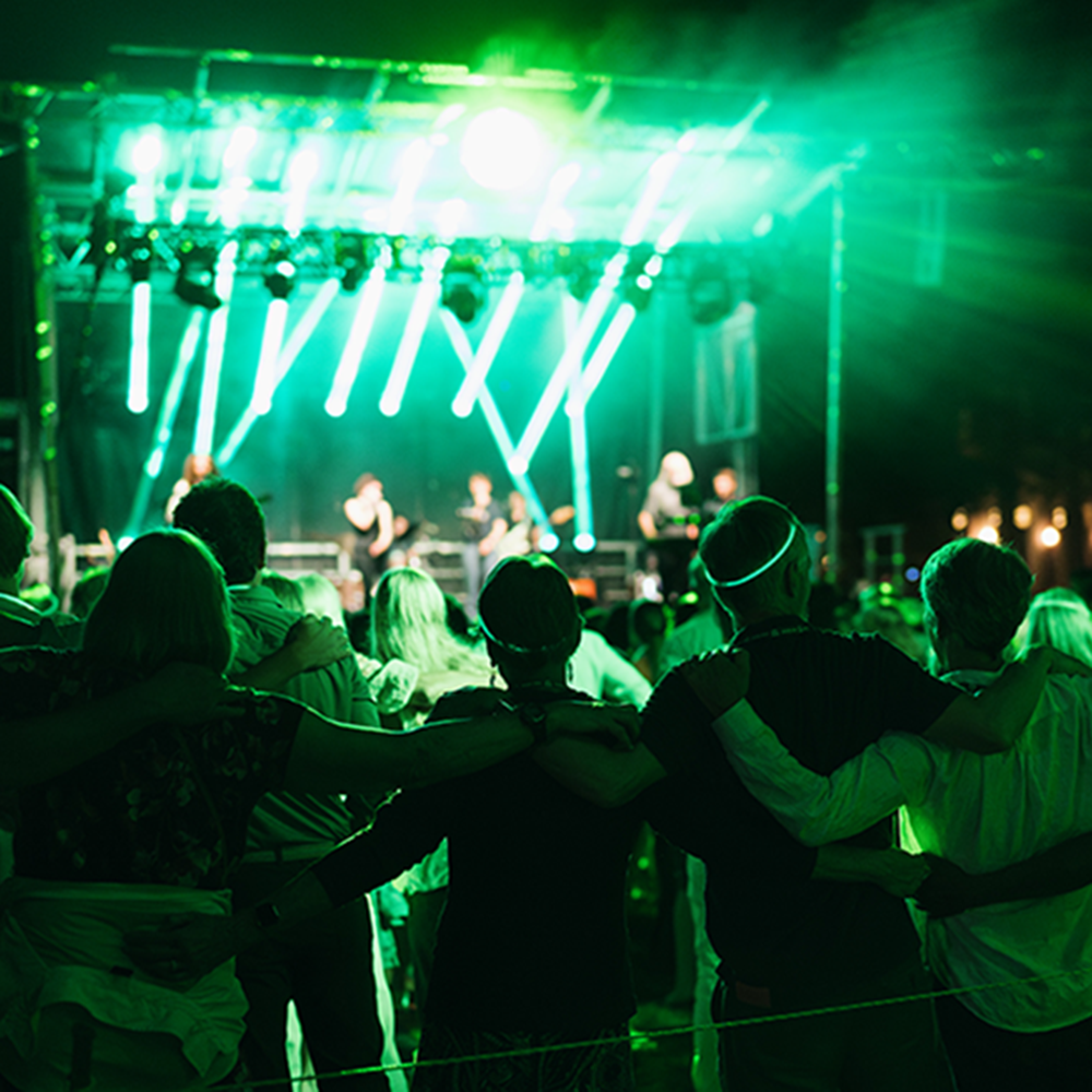 Reunions attendees arm-in-arm during the alma mater at the On the Green after dark celebration