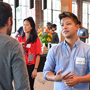 Two men speaking to each other at a networking event