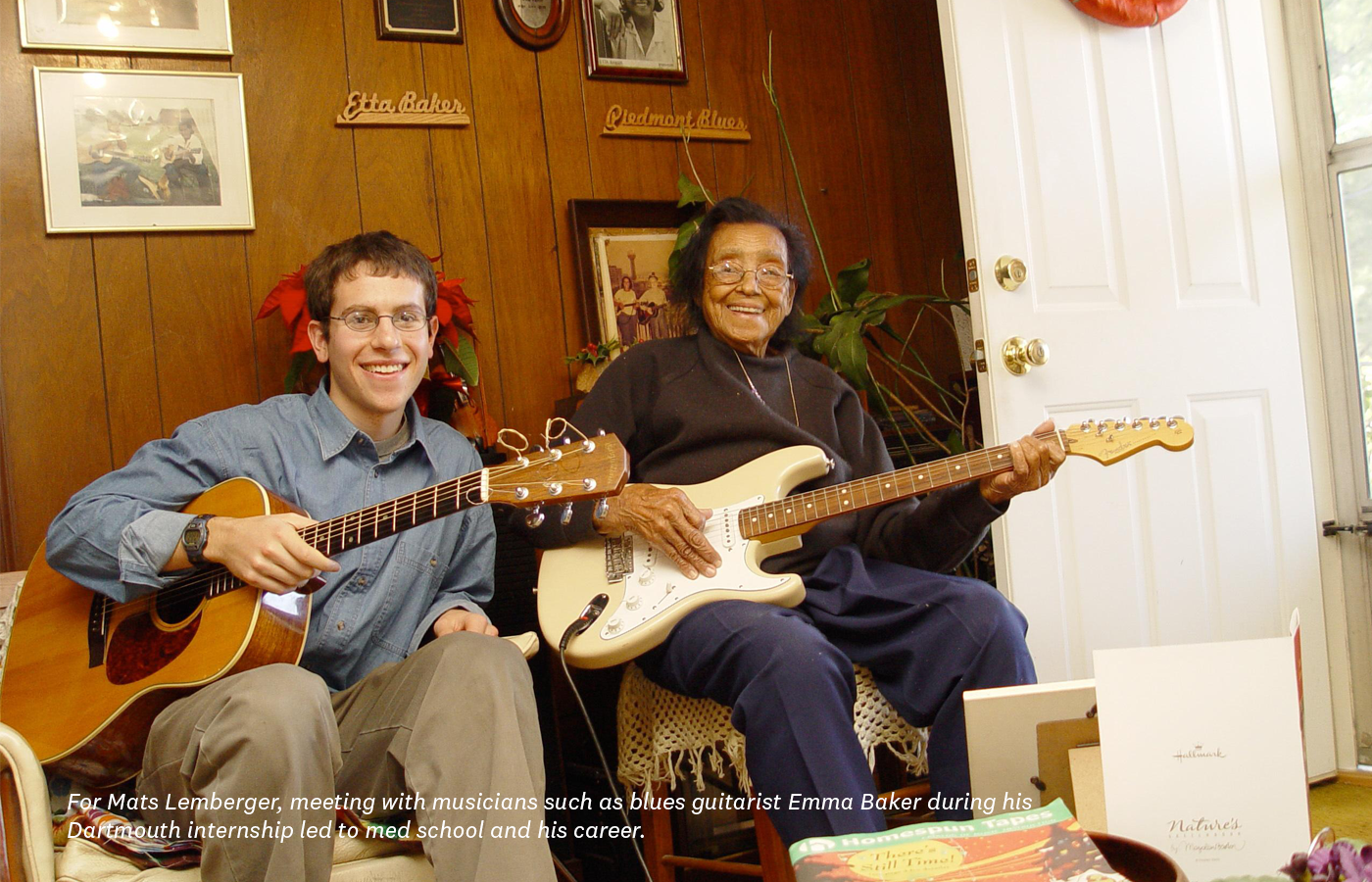 Mats Lemberger and Emma Baker seated, holding guitars and smiling